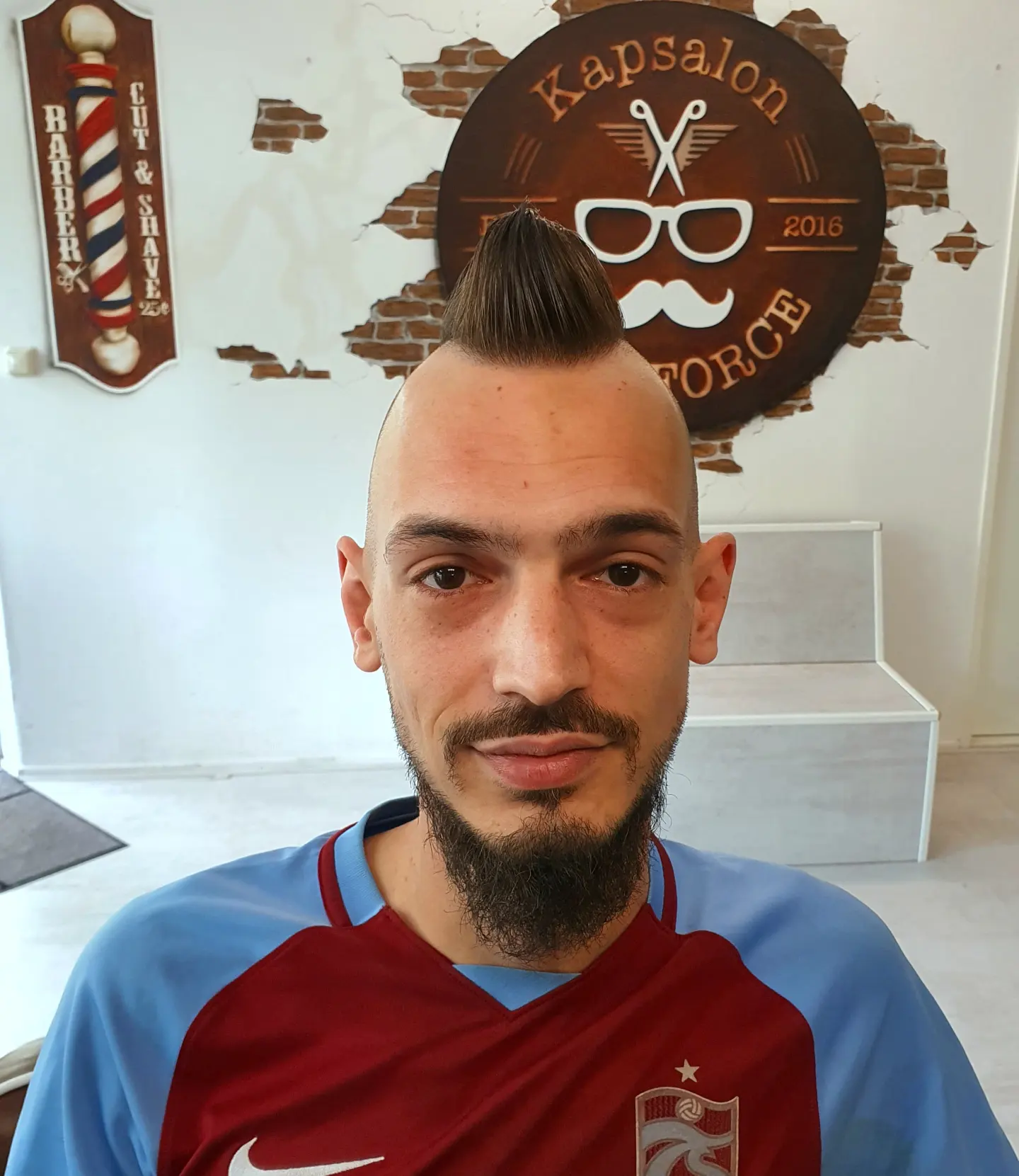 Hanenkam met skin fade en volle baard